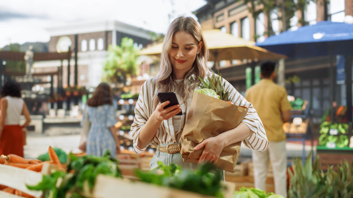 Persona utiliza su celular para pagar con tarjeta en un negocio en México.